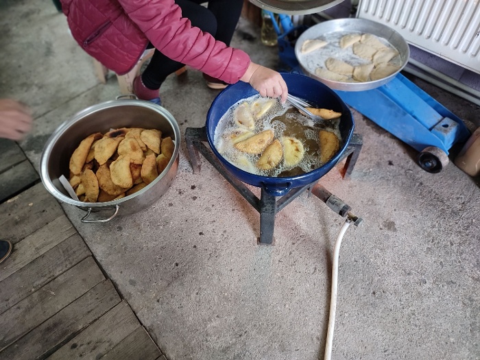 The meat filled dough is fried in hot oil in the garage